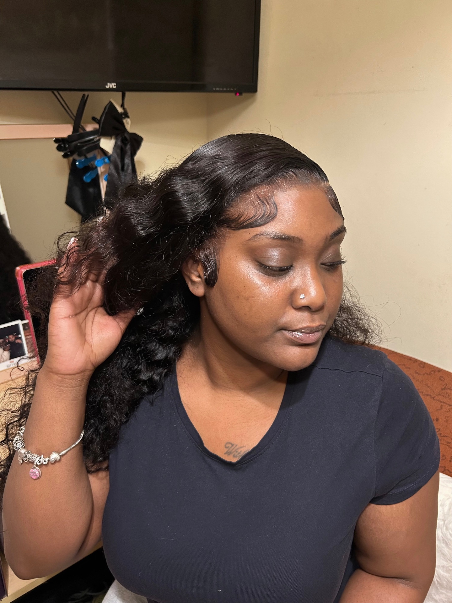 Side-parted wavy install with a sleek laid hairline and baby hairs