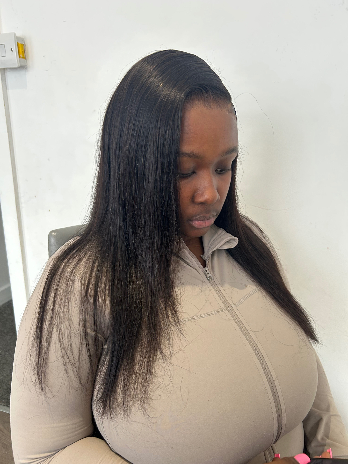 Long straight bone-straight install with a deep side part